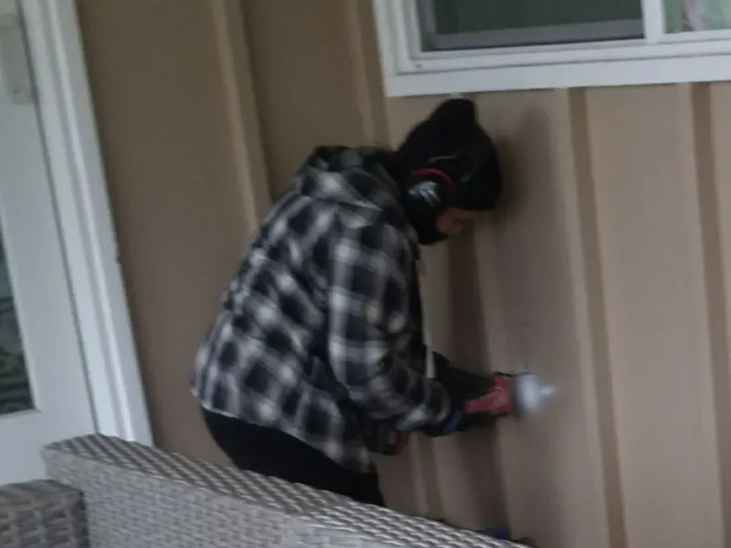 Professional electrician installing an exterior outlet in Sparta